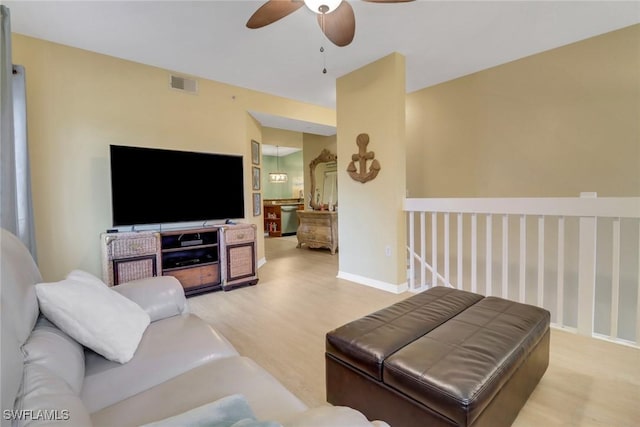 living room with ceiling fan and light hardwood / wood-style floors