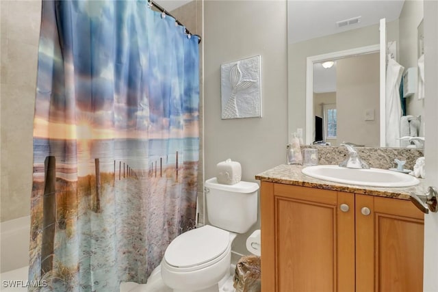 bathroom featuring toilet and vanity