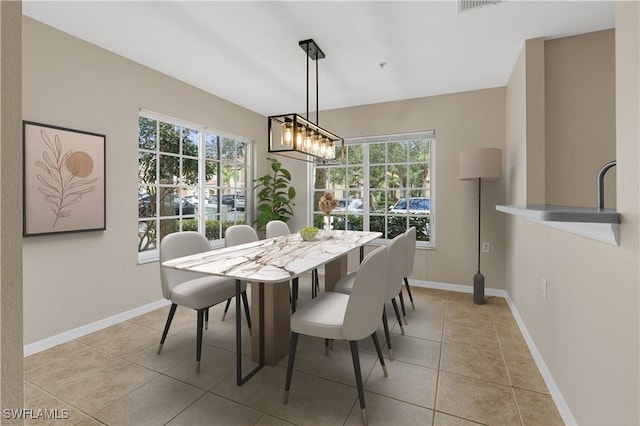 tiled dining area with a notable chandelier