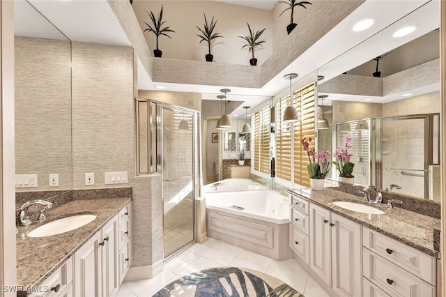 bathroom with tile patterned flooring, vanity, and separate shower and tub