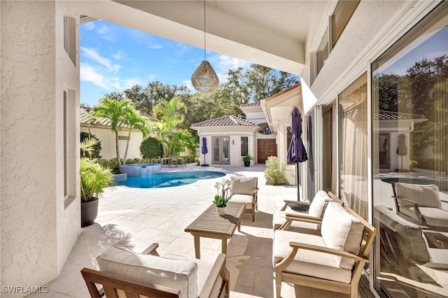 view of patio / terrace featuring outdoor lounge area, an outdoor structure, and a fenced in pool