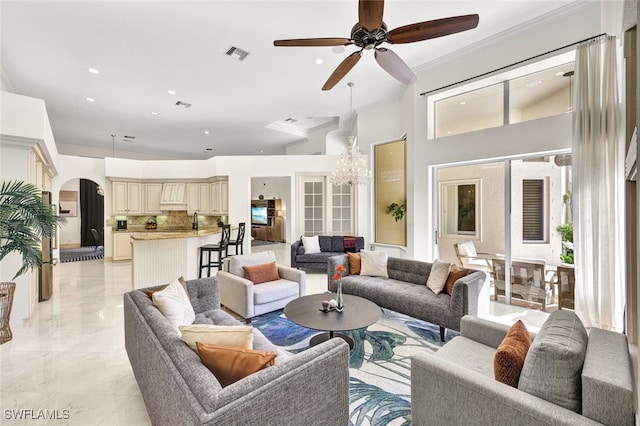 living room with crown molding and ceiling fan with notable chandelier