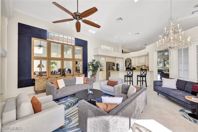 living room with crown molding, a towering ceiling, and ceiling fan with notable chandelier