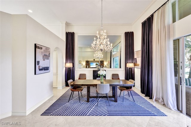 dining space with crown molding and an inviting chandelier