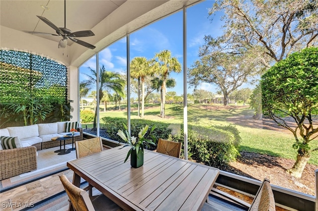 sunroom / solarium featuring ceiling fan