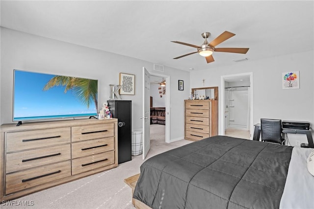 bedroom with light colored carpet, visible vents, ceiling fan, and ensuite bath