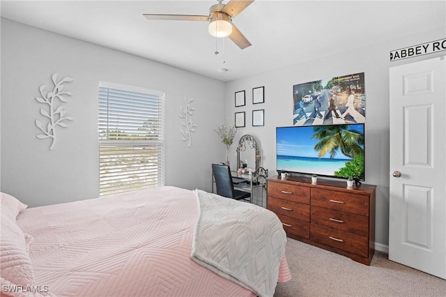 bedroom featuring light carpet and ceiling fan