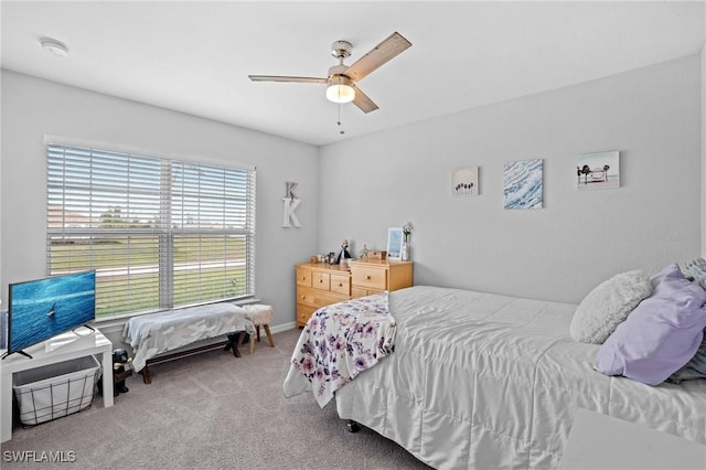 carpeted bedroom featuring ceiling fan and baseboards