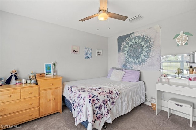 carpeted bedroom with a ceiling fan and visible vents