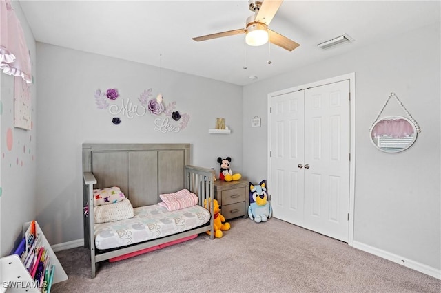 carpeted bedroom featuring a ceiling fan, baseboards, visible vents, and a closet