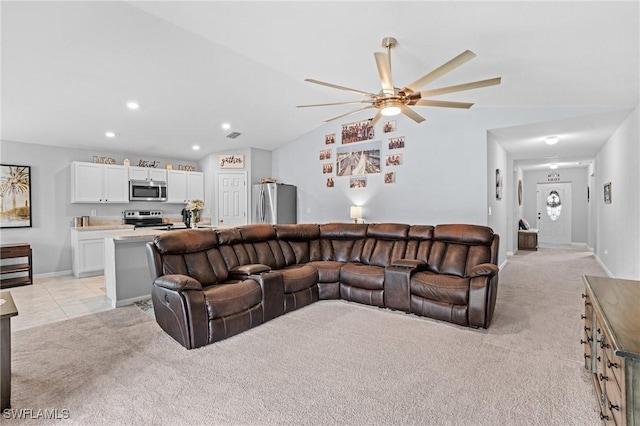 living room with ceiling fan, light colored carpet, and lofted ceiling