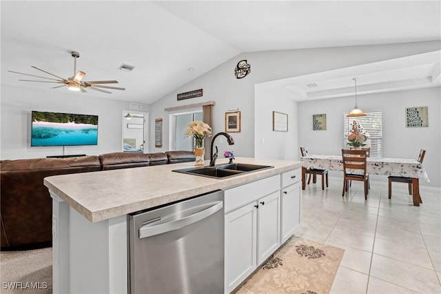 kitchen featuring a center island with sink, dishwasher, open floor plan, light countertops, and white cabinetry