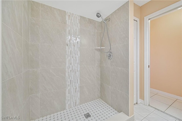 bathroom featuring tile patterned flooring and tiled shower