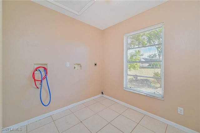 clothes washing area featuring electric dryer hookup, washer hookup, and light tile patterned floors