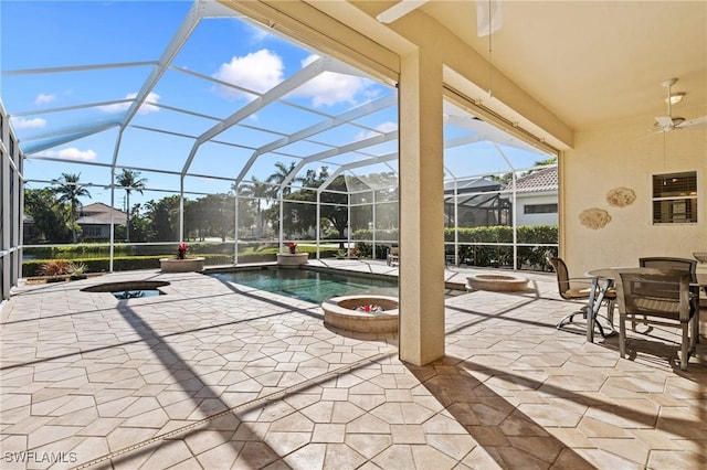 view of patio featuring a lanai, ceiling fan, and a pool with hot tub