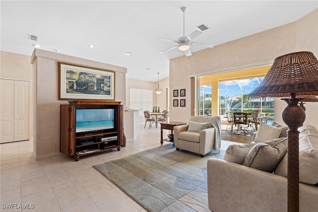 living room with ceiling fan and light tile patterned floors