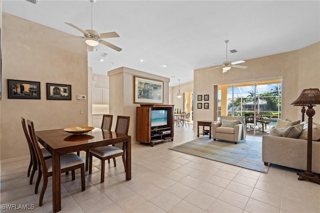 tiled dining room featuring ceiling fan and high vaulted ceiling