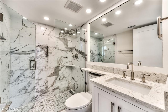 bathroom featuring walk in shower, vanity, and toilet