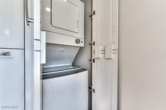 laundry area featuring stacked washing maching and dryer