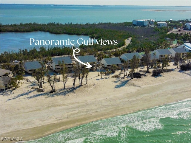 drone / aerial view featuring a view of the beach and a water view