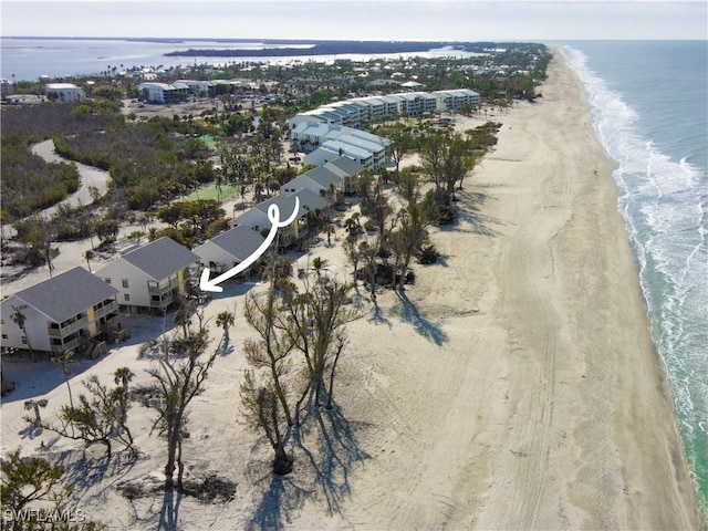 birds eye view of property featuring a water view and a view of the beach