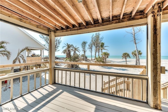 deck featuring a water view and a view of the beach