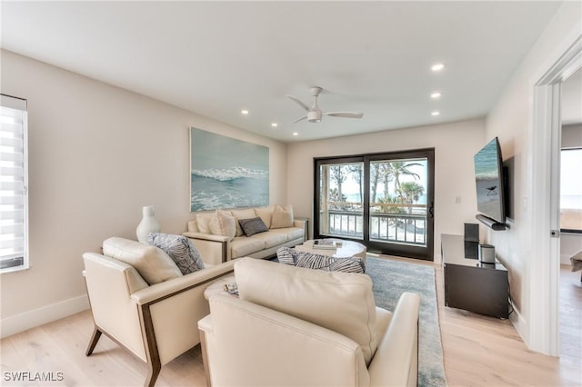 living room featuring ceiling fan and light wood-type flooring