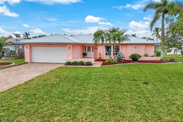 single story home with a garage and a front lawn