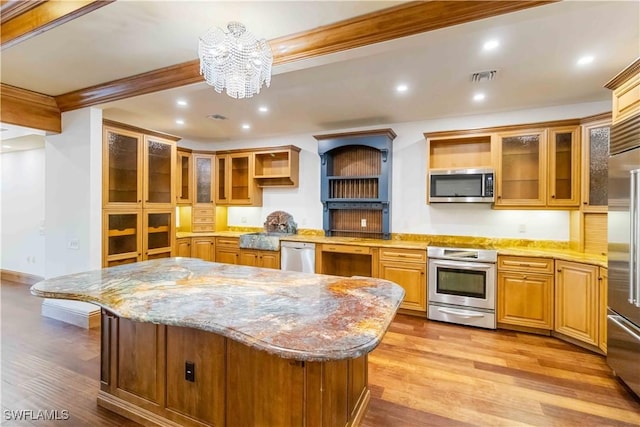 kitchen with crown molding, light hardwood / wood-style flooring, appliances with stainless steel finishes, light stone counters, and a kitchen island