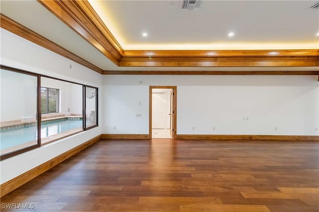 unfurnished room featuring ornamental molding and dark hardwood / wood-style flooring