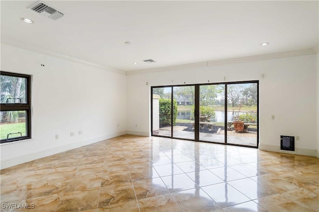 spare room with crown molding and french doors