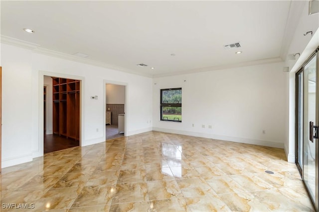 unfurnished room featuring crown molding