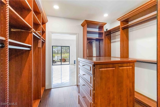 walk in closet featuring light hardwood / wood-style flooring