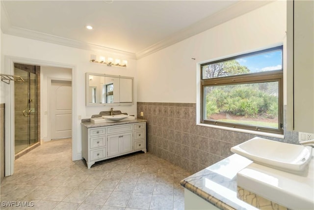 bathroom featuring tile walls, tile patterned flooring, vanity, ornamental molding, and an enclosed shower