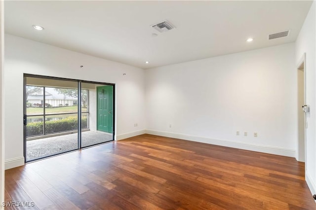 spare room with wood-type flooring