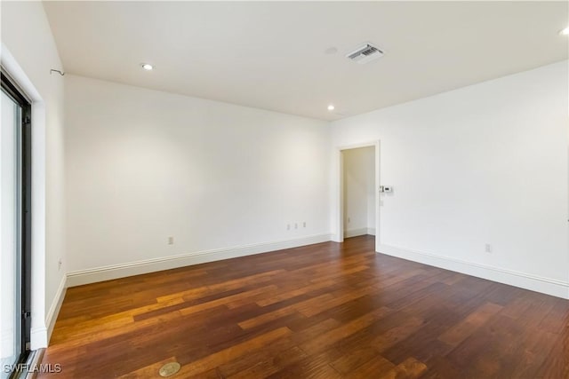 spare room featuring dark hardwood / wood-style floors