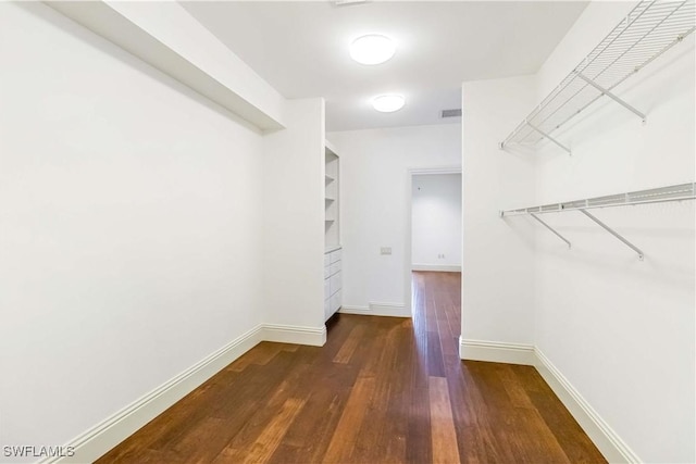 walk in closet featuring dark hardwood / wood-style floors