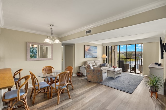 dining space with wood-type flooring, a notable chandelier, floor to ceiling windows, and ornamental molding