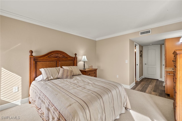 bedroom with dark hardwood / wood-style floors and ornamental molding