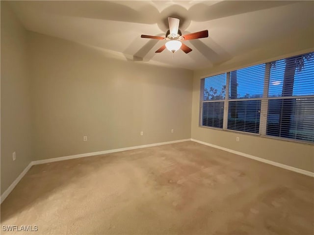 spare room with carpet floors and ceiling fan