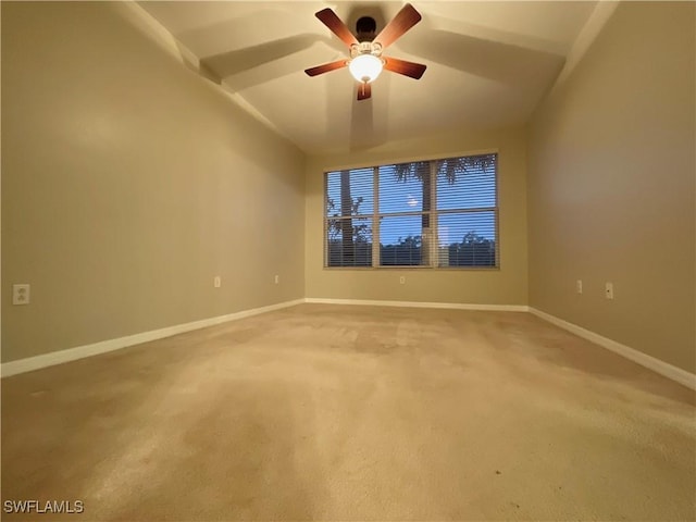 empty room with carpet floors, ceiling fan, and vaulted ceiling