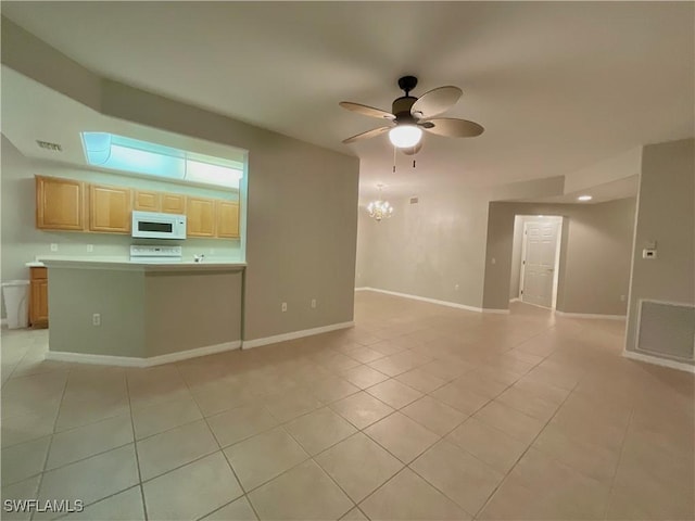 unfurnished living room featuring ceiling fan with notable chandelier and light tile patterned flooring