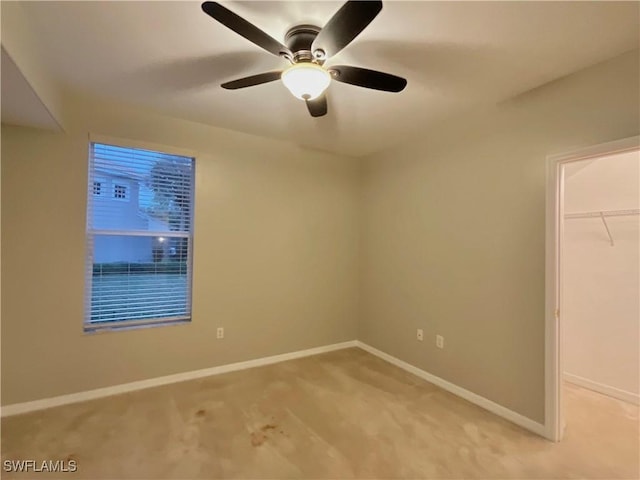 carpeted empty room with ceiling fan