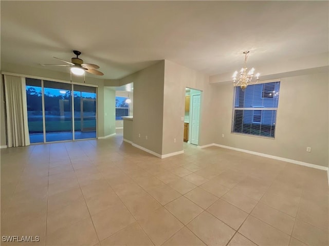 unfurnished room with ceiling fan with notable chandelier and light tile patterned floors