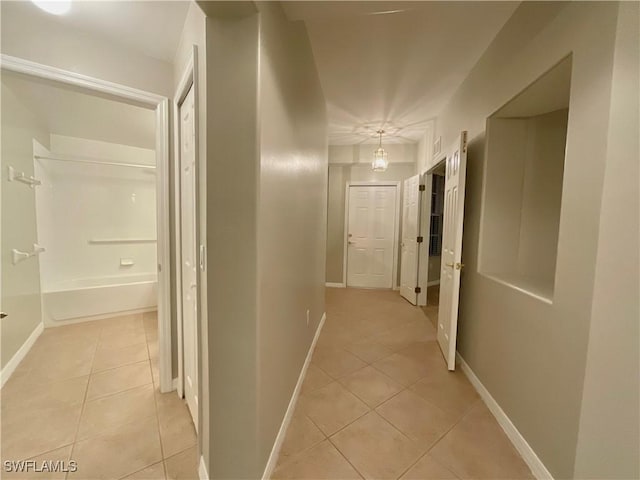 hallway with light tile patterned floors