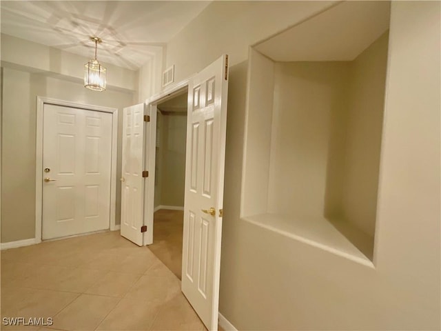 hall with light tile patterned flooring