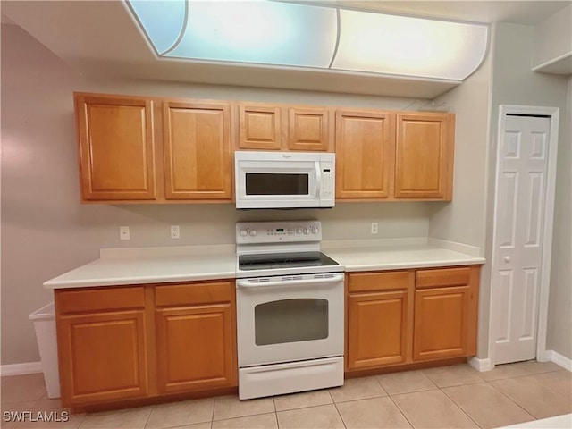 kitchen with white appliances and light tile patterned floors