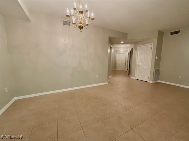 unfurnished room featuring light tile patterned floors and an inviting chandelier