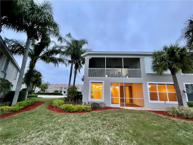 rear view of property featuring a yard