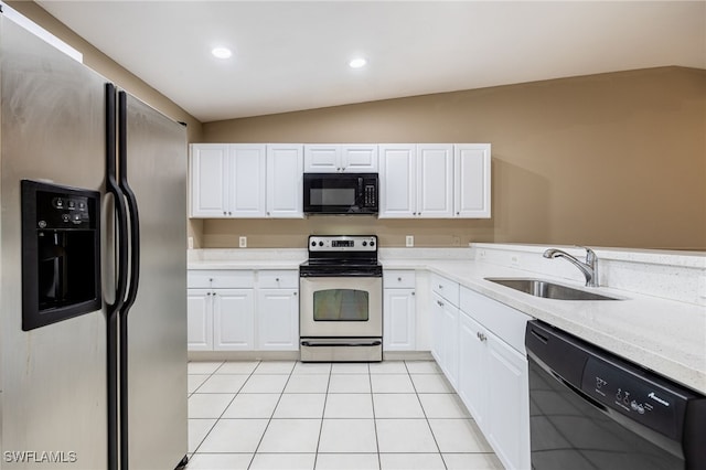 kitchen featuring black appliances, light tile patterned flooring, white cabinets, and lofted ceiling